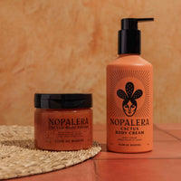 Nopalera cactus body polish and cream Flor de Madera on a textured surface with an orange background