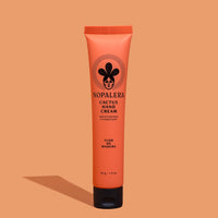 Tube of Nopalera Cactus Hand Cream Flor de Madera with a peach-colored background, featuring the product name and an illustration of a cactus.