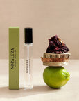 Nopalera Luxury Mexican travel spray perfume bottle and packaging with a lime and dried flowers on a neutral background