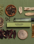 Nopalera Bosque Misticco perfume bottle with natural ingredients on a green background
