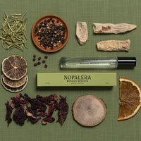 Nopalera Bosque Misticco perfume bottle with natural ingredients on a green background