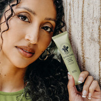 Woman holding a tube of cactus hand cream