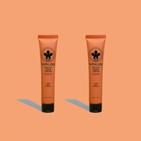 Two Nopalera cactus hand cream tubes in Flor de Madera scent on a peach background.
