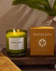 Nopalera Todos Santos scented candle in green glass jar with product box