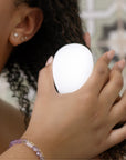 Person using Nopalera solid conditioner bar on curly hair
