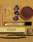 Nopalera Luxury Mexican fragrance travel spray perfume  dulce de cuerpo bottle with ingredients on a textured surface
