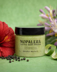 Jar of Nopalera Cactus Body Polish with a red flower and green background