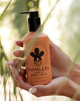 Nopalera cactus body cream Flor de Madera bottle held in hands with natural light.