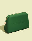 Green Nopalera cosmetic pouch with gold zipper and embossed logo on a neutral background.