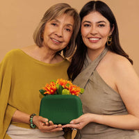Mother's day Nopalera gift with purchase. A Green Nopalera cosmetic pouch with gold zipper and embossed logo.