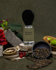 Perfume bottle labeled 'Bosque Móstico' by Nopalera surrounded by natural elements on a dark background