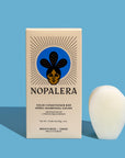 Packaged Nopalera solid conditioner bar displayed beside its box for moisturizing and shine.