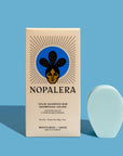Nopalera Moisturize and Shine shampoo bar with packaging on blue background