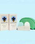 Nopalera shampoo and conditioner bars with storage pouch and soap dish on a light blue background