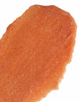 Close-up of a piece of Flor de Madera Body Polish on a white background