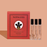 Nopalera travel fragrance trio with a red box on a peach background