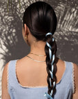 Nopalera woman with long braided hair styled with ribbon, representing results from Nopalera shampoo and conditioner bars