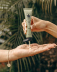 Person applying Nopalera cactus hand cream Bosque Místico with a natural background