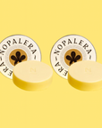 Two yellow citrus lotion bar with 'Nopalera' branding on a yellow background