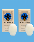 Packaged Nopalera solid conditioner bars displayed beside the products against a blue background.